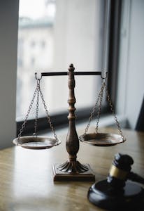 A scale balancing 'Efficiency' and 'Fairness' to represent the challenge of IRS AI audits.