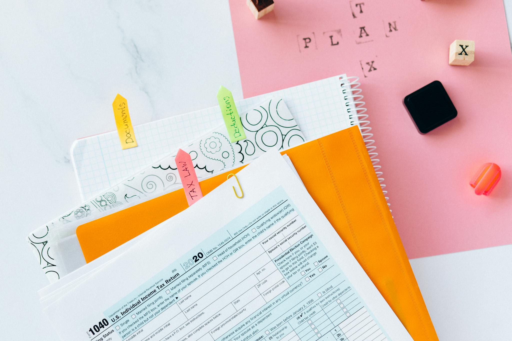 Overhead view of tax documents, financial statements and ledgers being reconciled for an SBA quality of earnings report